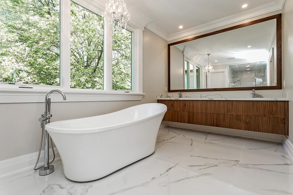 This is an example of a mid-sized transitional bathroom in Toronto with a corner tub, white tile, porcelain tile, grey walls, porcelain floors and white floor.