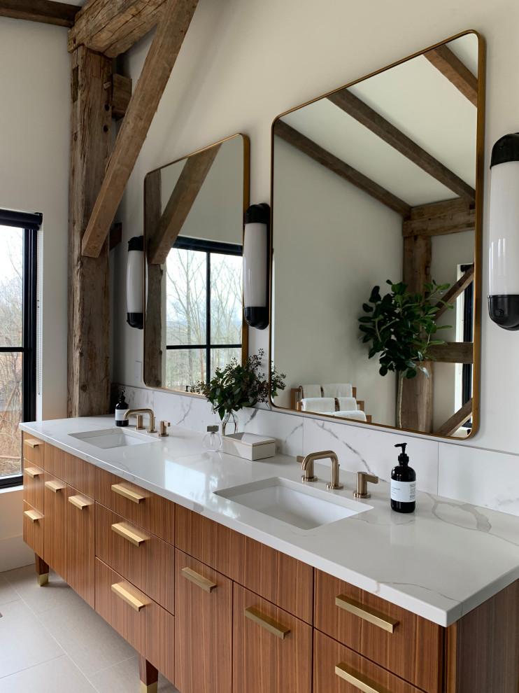 Inspiration for a large modern master bathroom in Cleveland with flat-panel cabinets, medium wood cabinets, a freestanding tub, an alcove shower, white walls, porcelain floors, an undermount sink, quartzite benchtops, white floor, a hinged shower door, white benchtops, an enclosed toilet, a double vanity, a freestanding vanity and exposed beam.