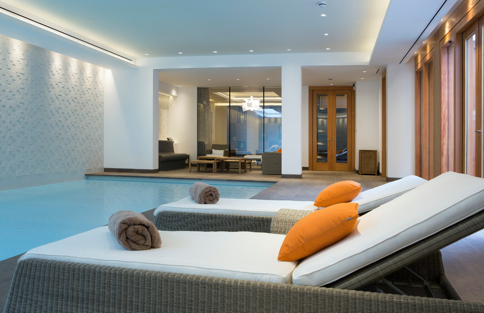 Design ideas for a large contemporary indoor rectangular pool in London with tile.