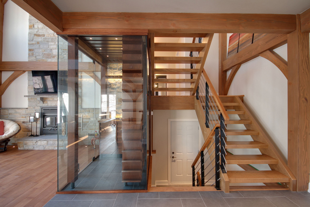 Inspiration for a contemporary wood u-shaped staircase in Montreal with open risers.
