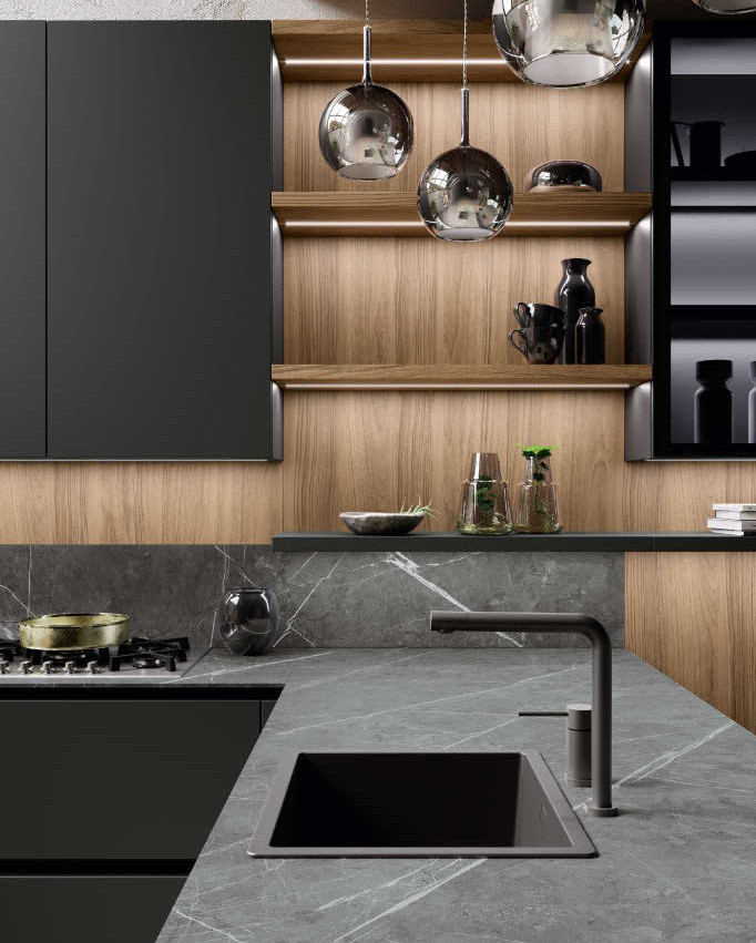 Inspiration for a medium sized modern l-shaped open plan kitchen in San Diego with a single-bowl sink, flat-panel cabinets, beige cabinets, engineered stone countertops, black splashback, engineered quartz splashback, black appliances, light hardwood flooring, a breakfast bar and black worktops.