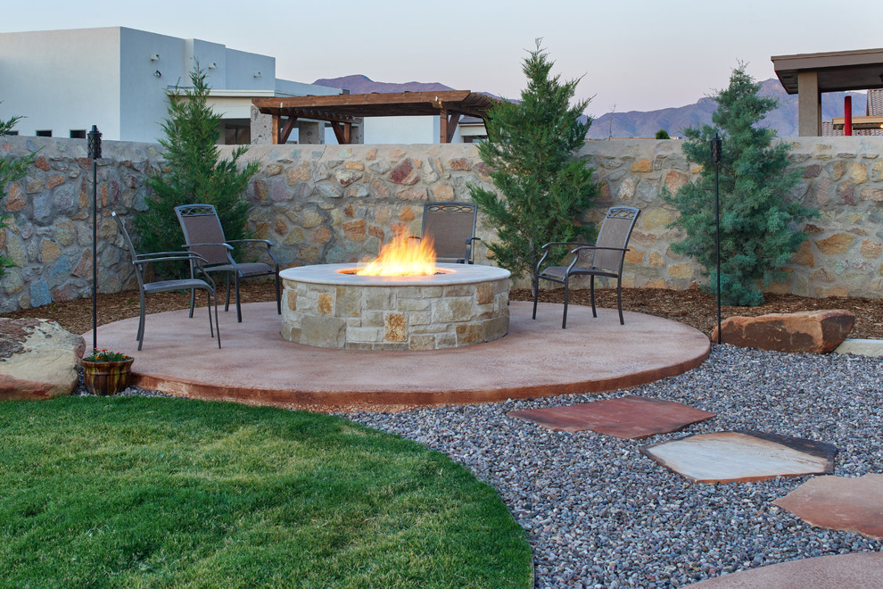 Photo of a mid-sized traditional backyard full sun xeriscape in Other with a fire feature and concrete pavers.