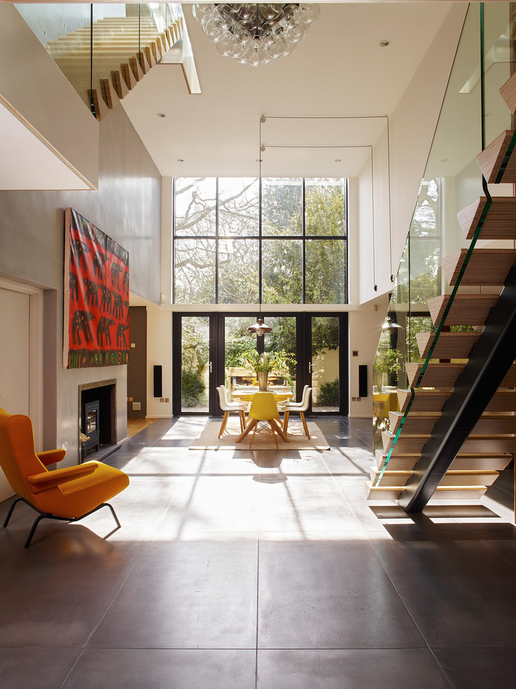 Inspiration for a contemporary formal open concept living room in London with concrete floors.