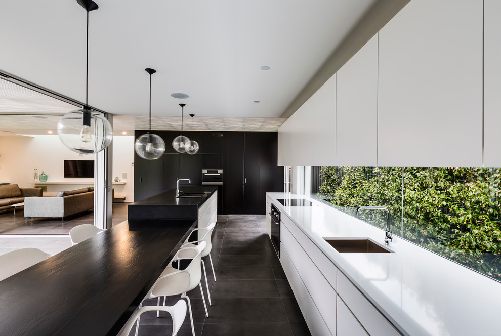 Contemporary kitchen in Sydney with an undermount sink, flat-panel cabinets, white cabinets, wood benchtops and with island.