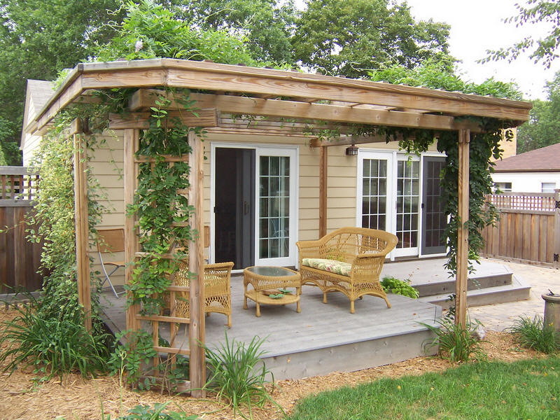 Small mountain style backyard deck photo in Minneapolis with a pergola