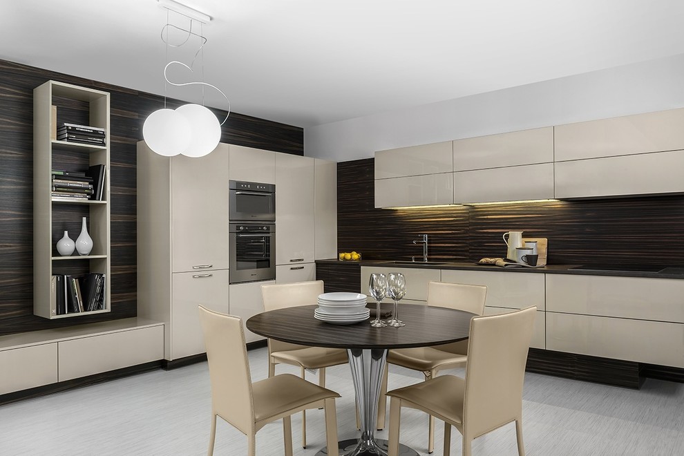This is an example of a modern l-shaped open plan kitchen in New York with an undermount sink, flat-panel cabinets, beige cabinets, brown splashback, timber splashback and stainless steel appliances.