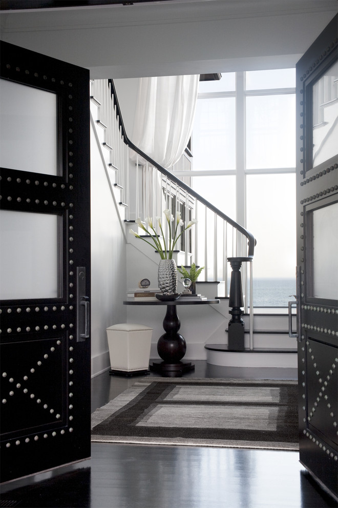 Design ideas for a transitional foyer in Boston with white walls, dark hardwood floors and black floor.