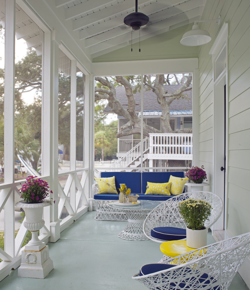 Mid-sized beach style front yard verandah in Atlanta with concrete slab and a roof extension.
