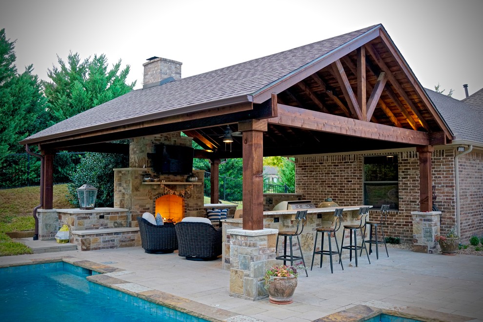 This is an example of a mid-sized traditional backyard patio in Dallas with a fire feature, brick pavers and a gazebo/cabana.