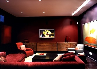 Inspiration for a mid-sized modern enclosed home theatre in New York with multi-coloured walls, ceramic floors and a wall-mounted tv.