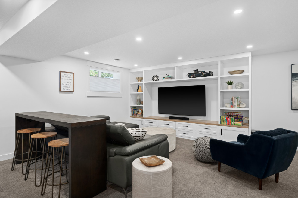 This is an example of a small contemporary open plan home cinema in Calgary with white walls, carpet, a wall mounted tv and grey floors.