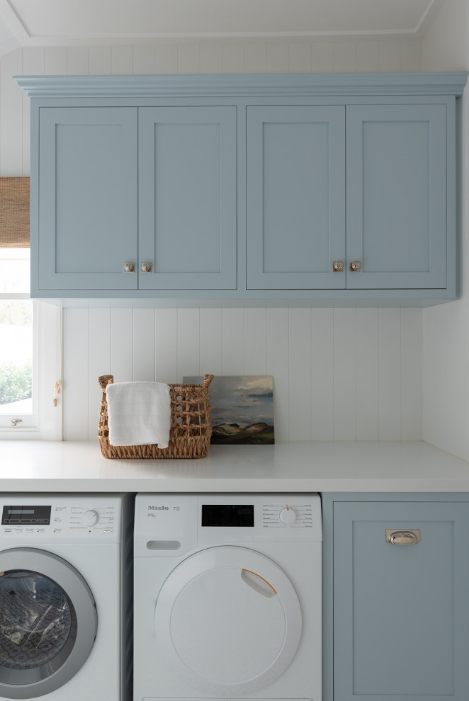 Inspiration for a laundry room in Perth with a farmhouse sink, shaker cabinets, blue cabinets, a side-by-side washer and dryer and white benchtop.