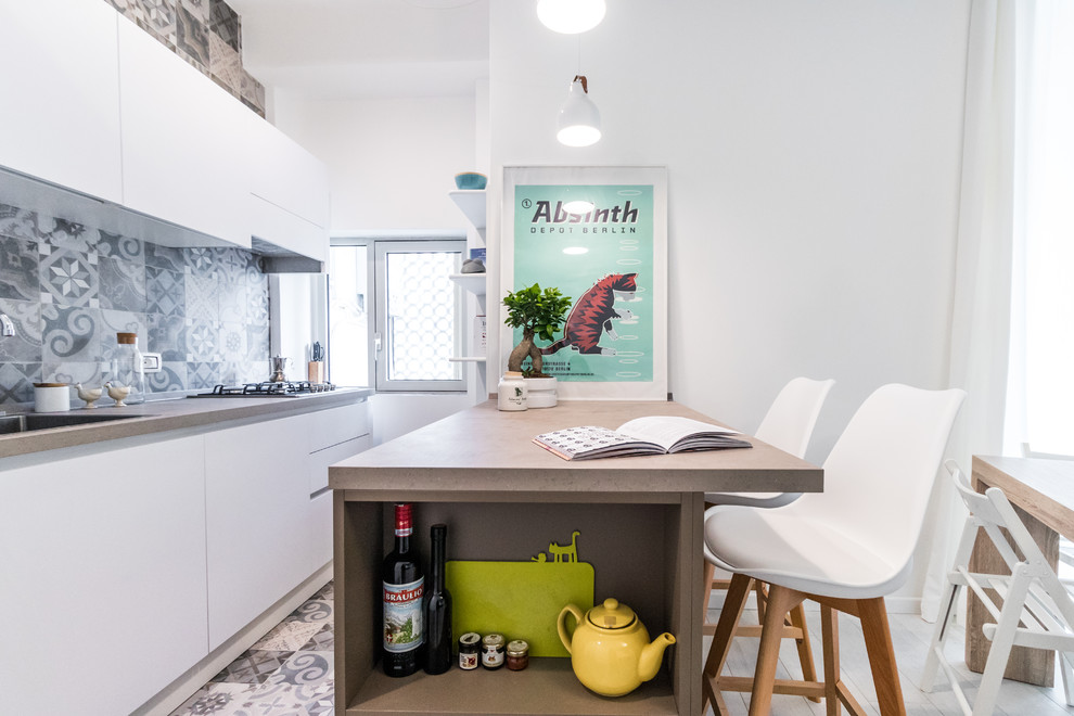 This is an example of a scandinavian galley eat-in kitchen in Milan with an undermount sink, flat-panel cabinets, white cabinets, blue splashback, panelled appliances, a peninsula, blue floor and beige benchtop.