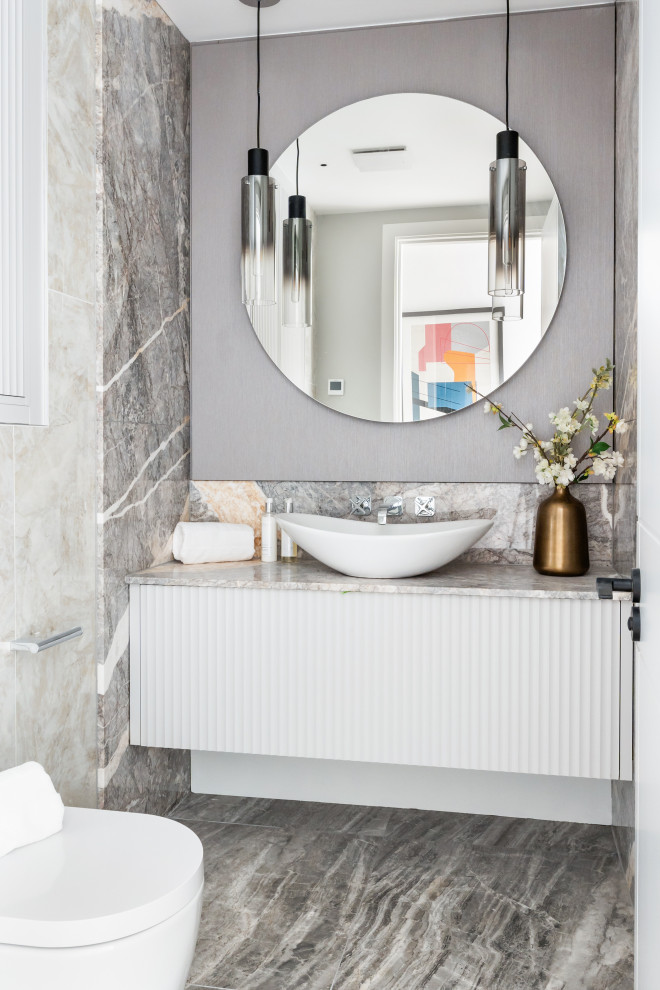 Contemporary cloakroom in London with flat-panel cabinets, white cabinets, a vessel sink, grey floors, grey worktops and a floating vanity unit.