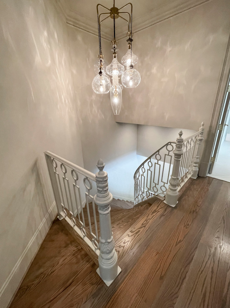 Staircase - huge transitional wooden floating metal railing and wall paneling staircase idea in DC Metro with wooden risers