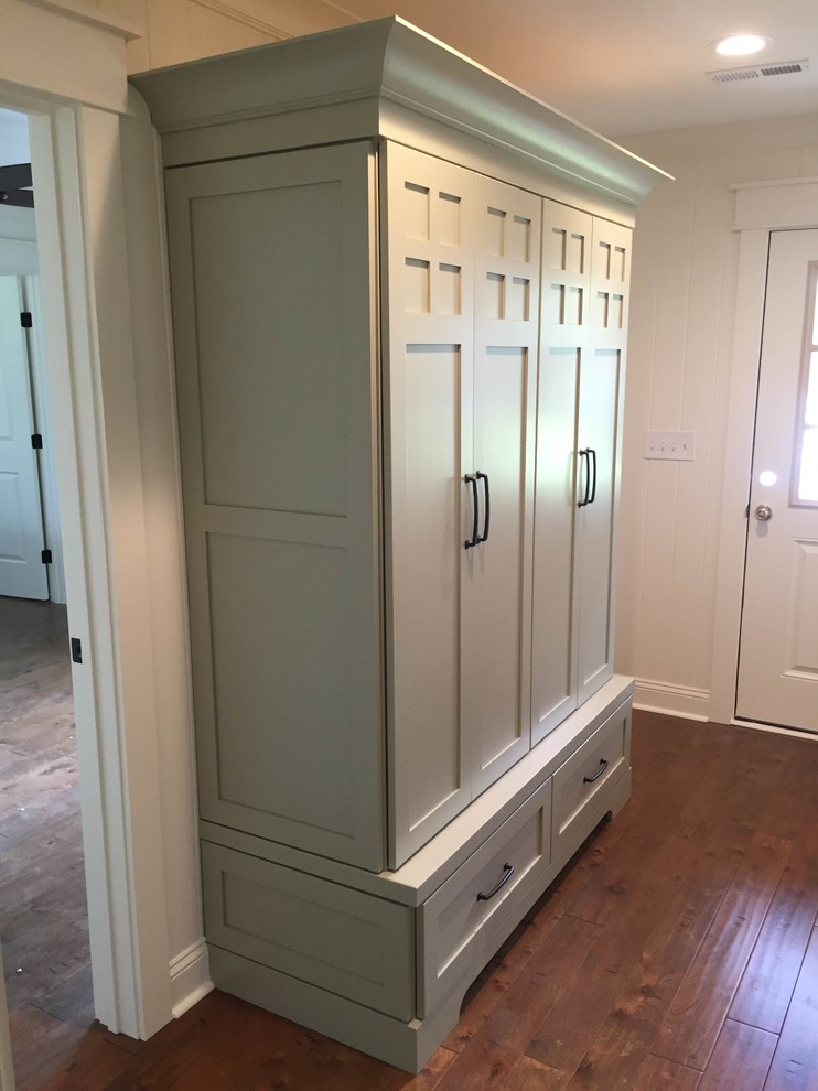 Inspiration for a mid-sized transitional medium tone wood floor foyer remodel