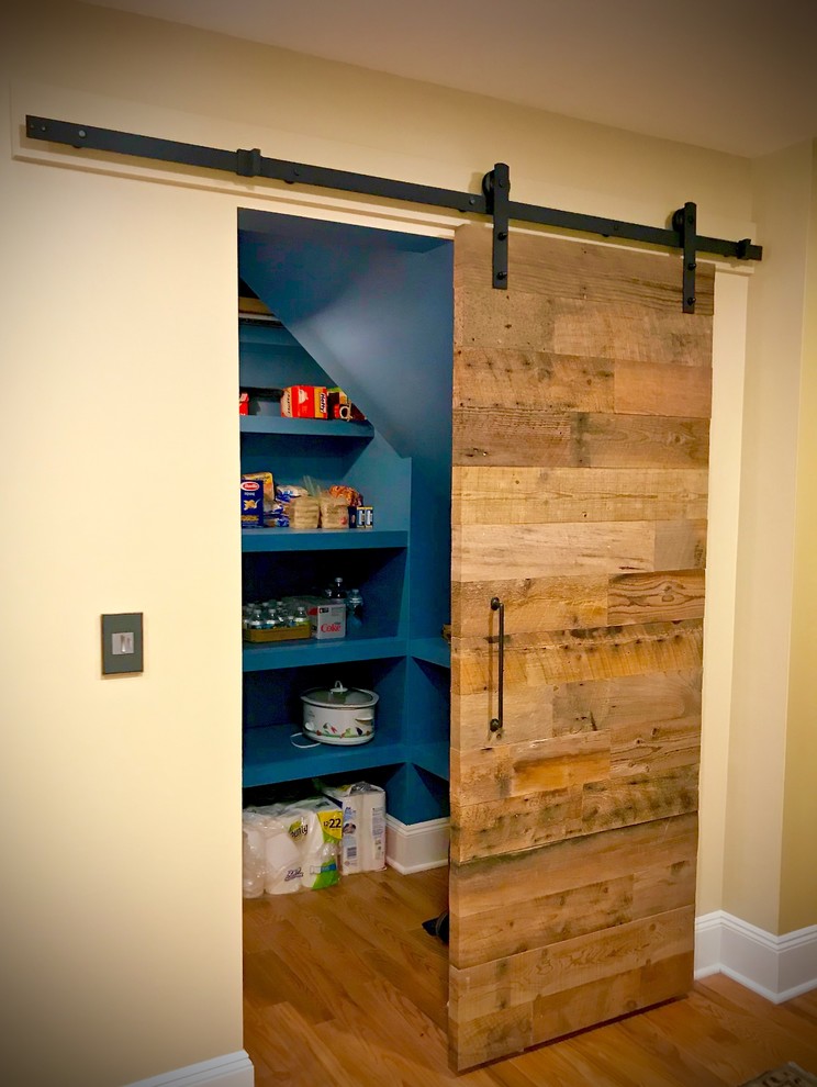 Large mountain style l-shaped medium tone wood floor and brown floor eat-in kitchen photo with a farmhouse sink, flat-panel cabinets, blue cabinets, concrete countertops, red backsplash, brick backsplash, stainless steel appliances, an island and white countertops
