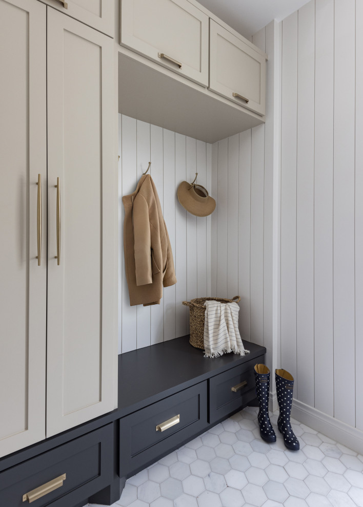 Transitional marble floor and shiplap wall entryway photo in Houston with white walls