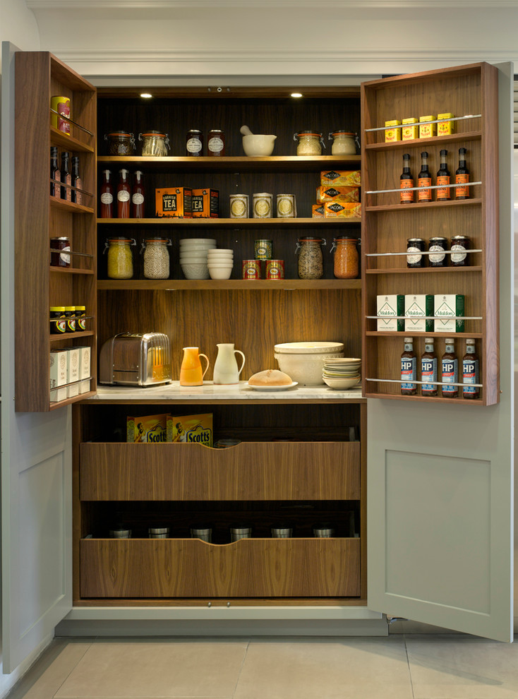 Photo of a large transitional kitchen pantry in London with grey cabinets.