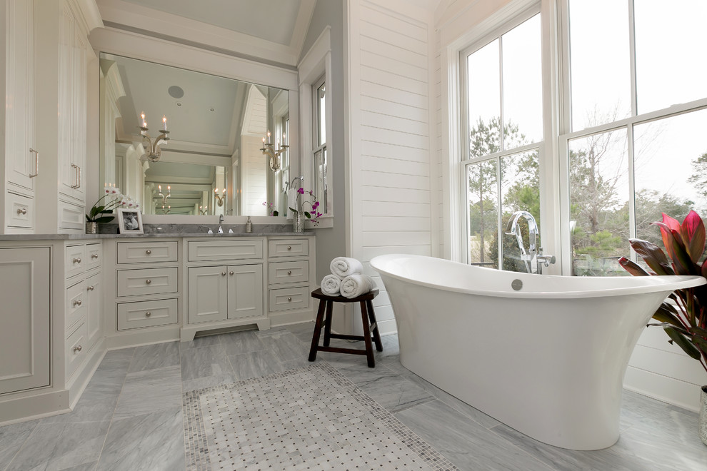 This is an example of a transitional bathroom in Charleston with recessed-panel cabinets, grey cabinets and gray tile.