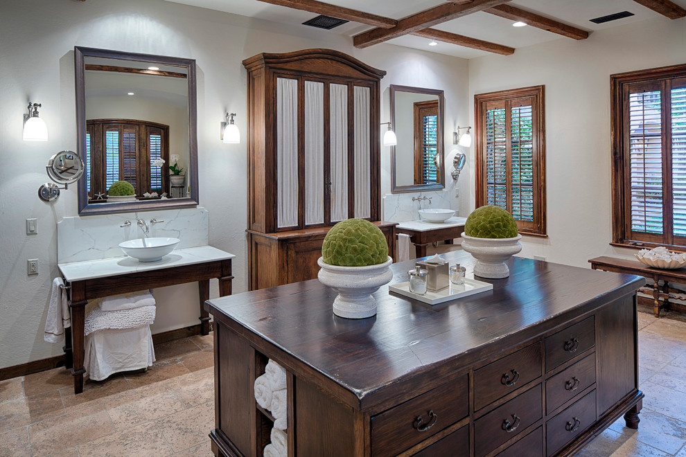 Inspiration for a large mediterranean master bathroom in Atlanta with dark wood cabinets, white walls, limestone floors, a vessel sink, marble benchtops and flat-panel cabinets.