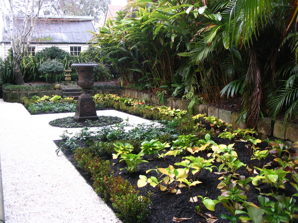 Traditional front yard driveway in Sydney with a water feature.