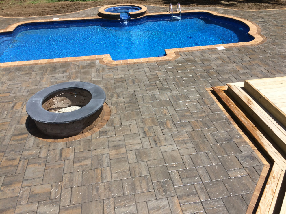 Hot tub - large transitional backyard concrete paver and custom-shaped hot tub idea