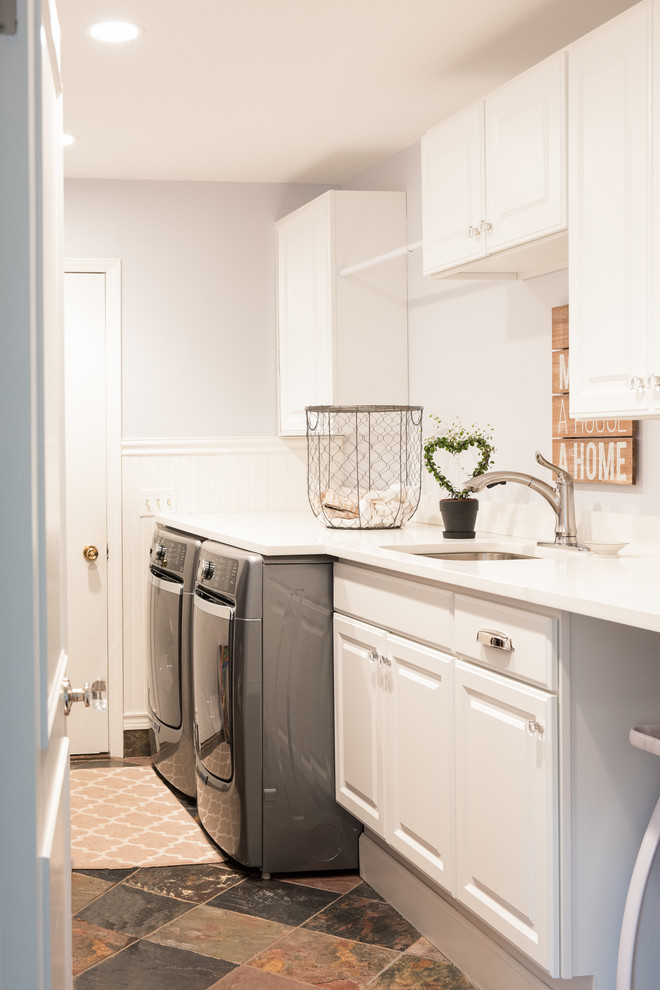 Inspiration for a small transitional galley dedicated laundry room in Detroit with an undermount sink, raised-panel cabinets, white cabinets, quartz benchtops, white walls, slate floors and a side-by-side washer and dryer.