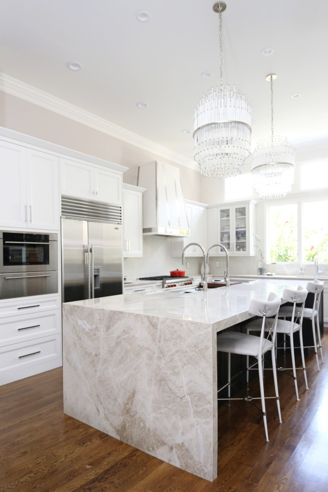 Inspiration for a huge transitional medium tone wood floor and brown floor eat-in kitchen remodel with an undermount sink, recessed-panel cabinets, white cabinets, quartzite countertops, white backsplash, ceramic backsplash, stainless steel appliances, an island and white countertops