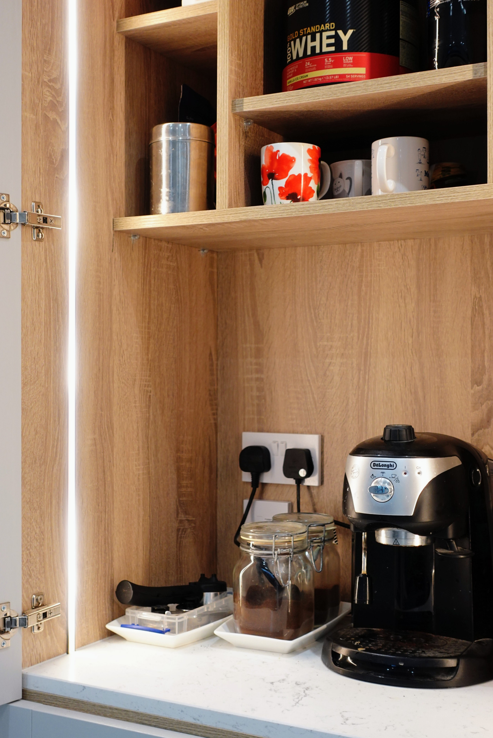 pantry, appliance garage, dresser, larder, lighting, kitchen design in Other with a drop-in sink, shaker cabinets, medium tone wood cabinets, quart