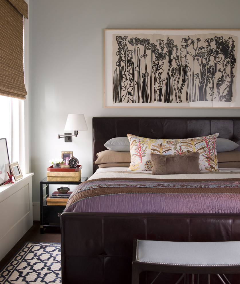 This is an example of a contemporary bedroom in New York with grey walls.