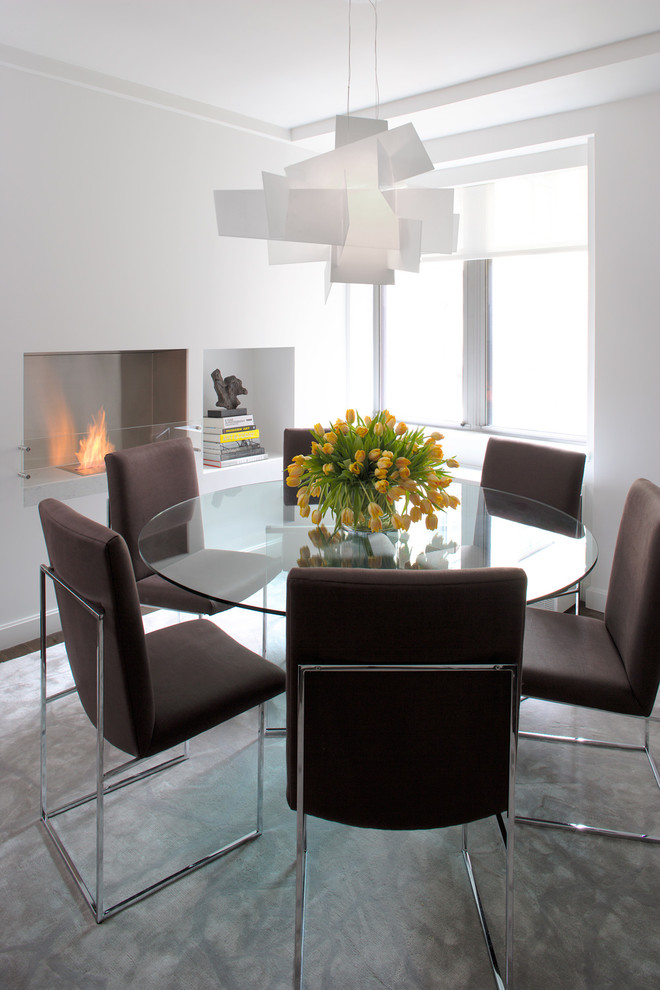 Photo of a contemporary dining room in New York with white walls.