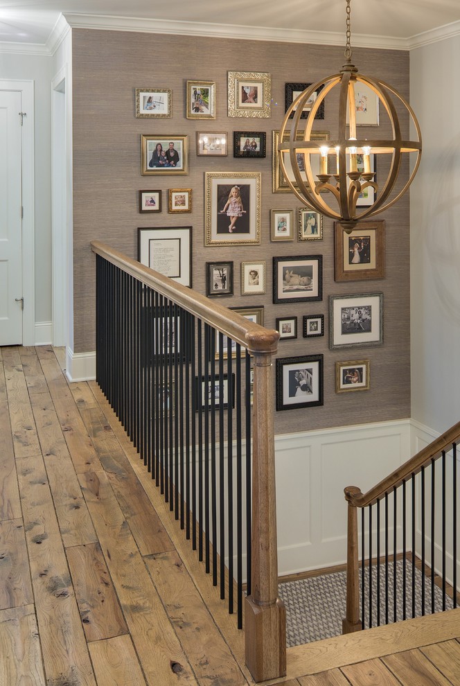 This is an example of a mid-sized traditional hallway in Minneapolis with brown walls and medium hardwood floors.