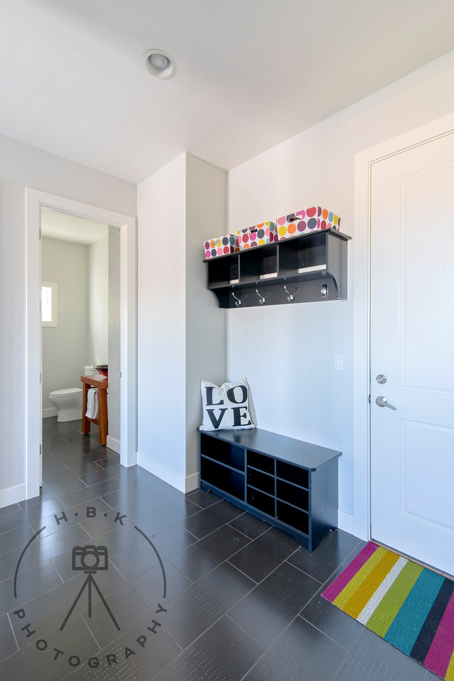 Mudroom - mid-sized ceramic tile and black floor mudroom idea with white walls