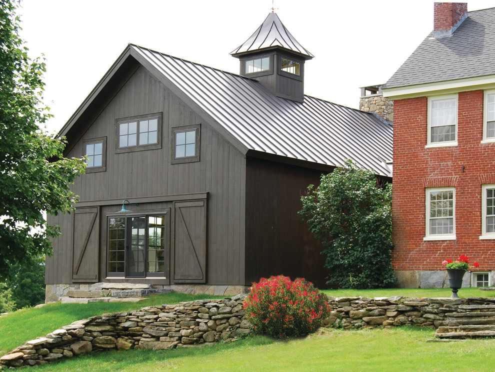 Design ideas for a medium sized farmhouse two floor house exterior in Burlington with wood cladding.