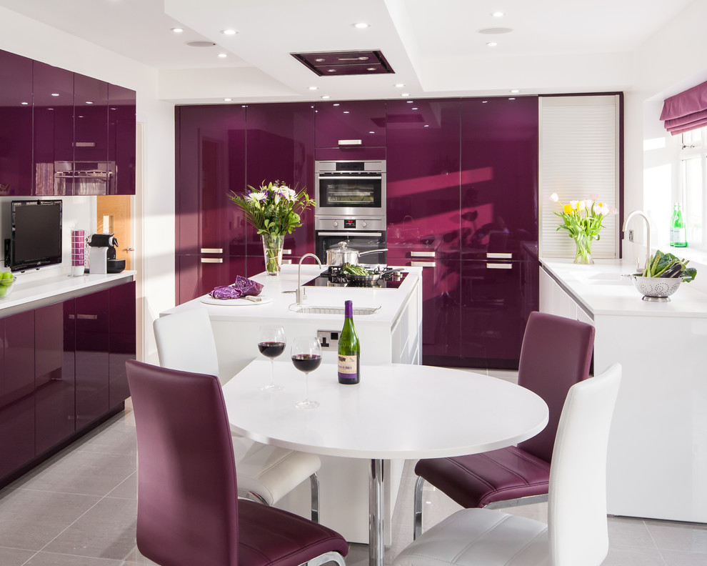 This is an example of a modern kitchen in Kent with flat-panel cabinets, white cabinets, panelled appliances, porcelain floors and with island.