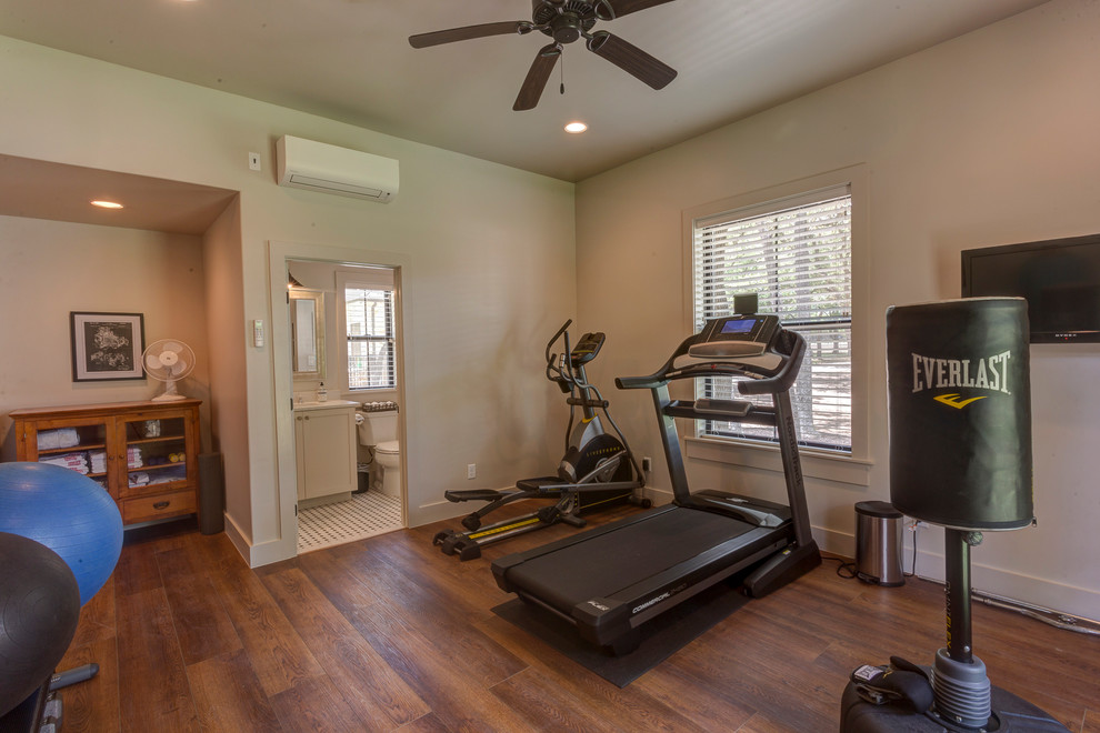Design ideas for a mid-sized country multipurpose gym in Austin with white walls, medium hardwood floors and brown floor.