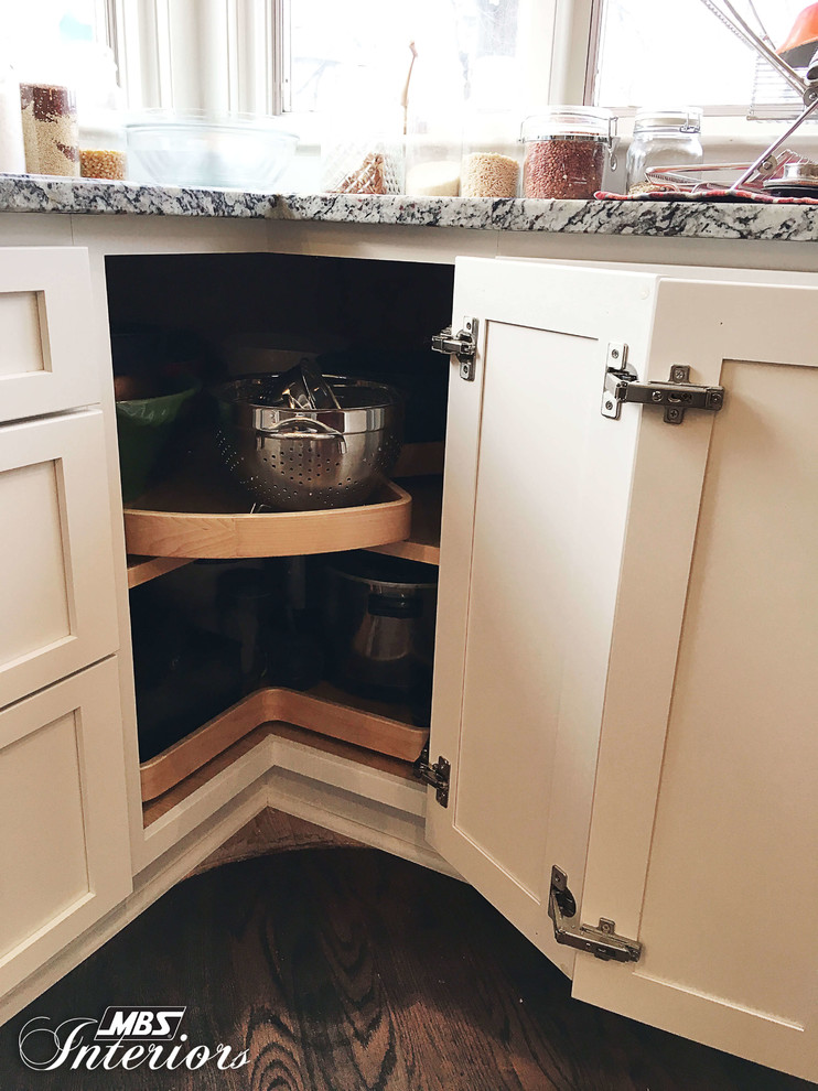 Inspiration for a huge transitional u-shaped medium tone wood floor and brown floor eat-in kitchen remodel with an undermount sink, shaker cabinets, white cabinets, granite countertops, white backsplash, subway tile backsplash, stainless steel appliances and an island