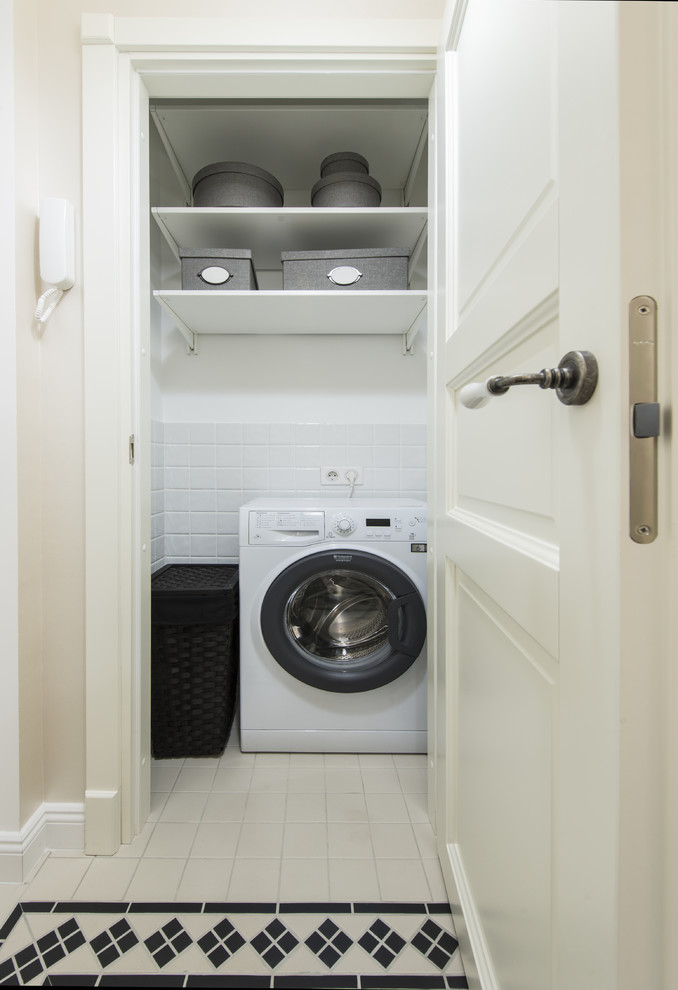 Design ideas for a traditional laundry room in Moscow with white walls.