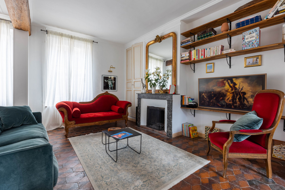 Inspiration for a mid-sized eclectic open concept living room in Paris with white walls, terra-cotta floors, a standard fireplace, a stone fireplace surround, a wall-mounted tv, orange floor and exposed beam.