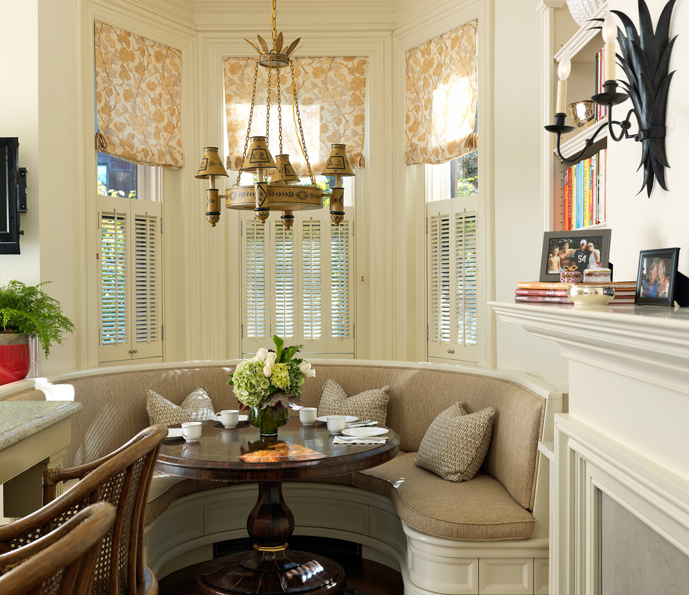 This is an example of a traditional dining room in Boston with white walls.