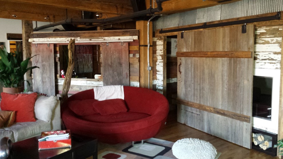 Inspiration for a large rustic look-out light wood floor and brown floor home design remodel in Phoenix with brown walls, a standard fireplace and a wood fireplace surround
