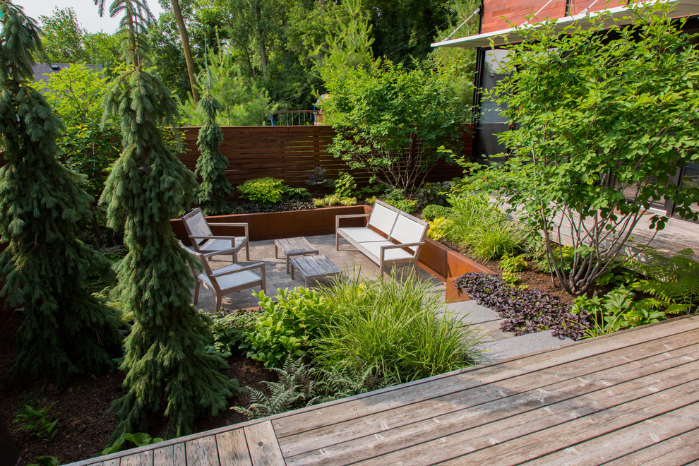 Photo of a small modern courtyard partial sun garden in Minneapolis with concrete pavers.