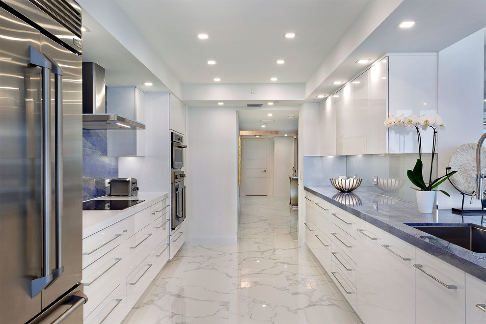Inspiration for a mid-sized contemporary galley eat-in kitchen in Miami with an undermount sink, flat-panel cabinets, white cabinets, marble benchtops, blue splashback, marble splashback, stainless steel appliances, marble floors, no island, multi-coloured floor and blue benchtop.
