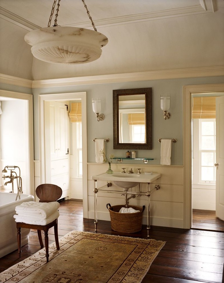 Design ideas for a large country master bathroom in New York with open cabinets, a freestanding tub, blue walls, dark hardwood floors, a console sink and brown floor.