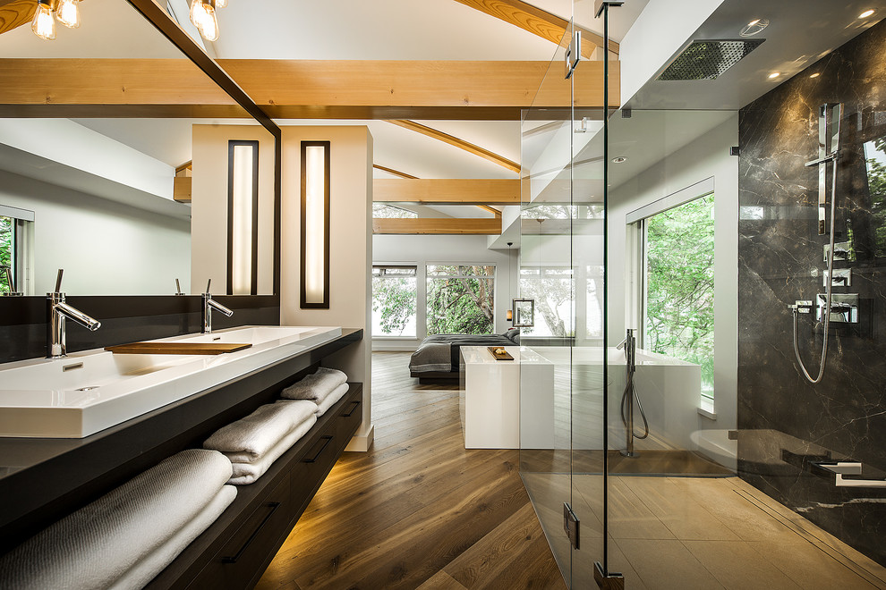 Small contemporary master bathroom in Vancouver with a vessel sink, flat-panel cabinets, dark wood cabinets, a corner shower, a wall-mount toilet, white walls, engineered quartz benchtops, brown tile, porcelain tile, porcelain floors and a freestanding tub.