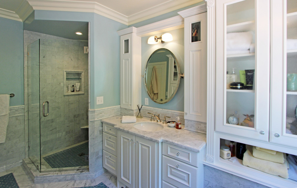 Inspiration for a large traditional master bathroom in San Luis Obispo with furniture-like cabinets, white cabinets, a claw-foot tub, an alcove shower, white tile, marble, blue walls, marble floors, an undermount sink, marble benchtops, a hinged shower door, grey benchtops, a single vanity, decorative wall panelling and a built-in vanity.