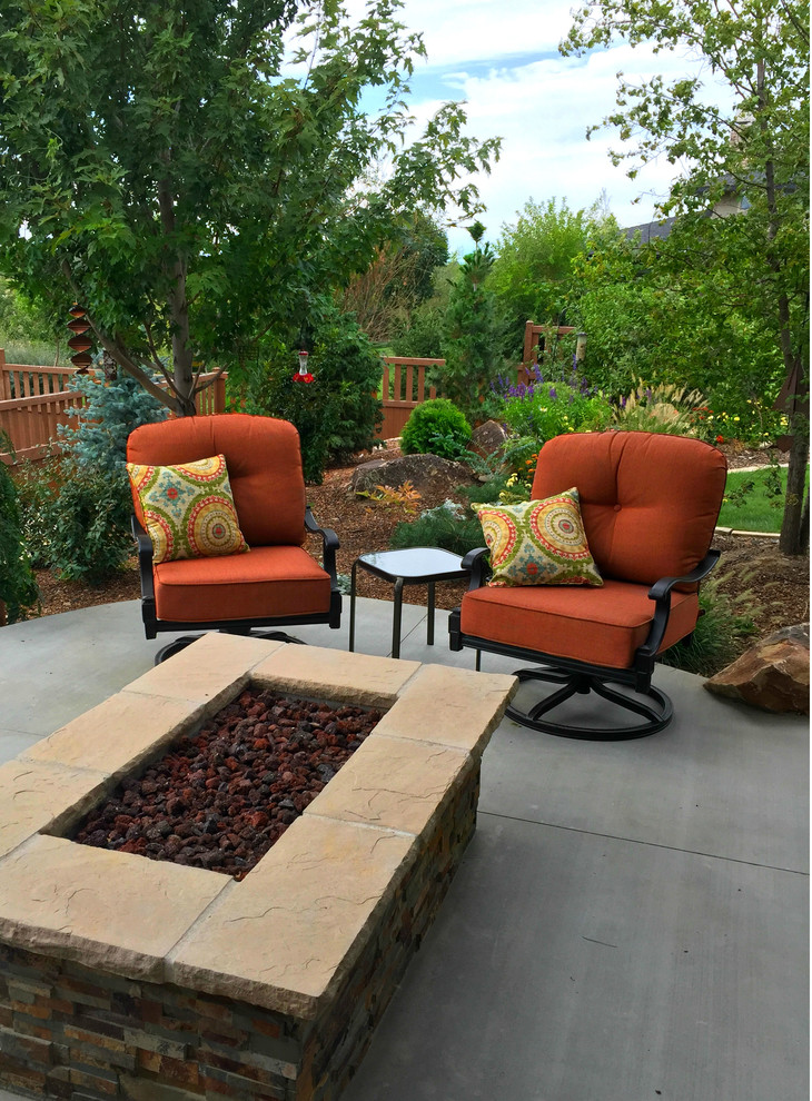 Photo of a mid-sized contemporary backyard patio in Boise with a fire feature, concrete slab and no cover.