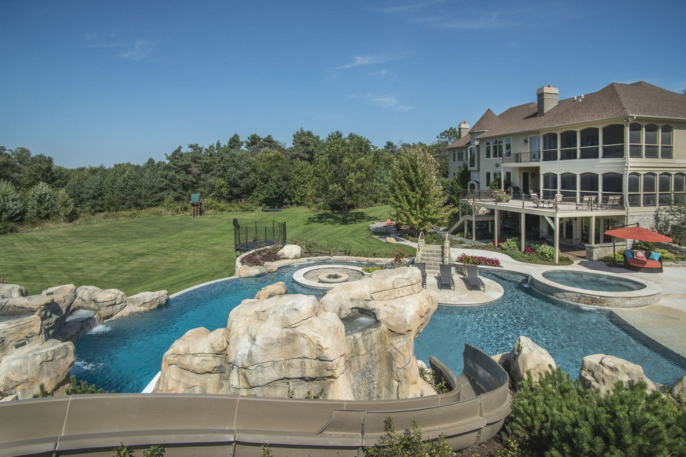 Example of a huge backyard stone and custom-shaped infinity water slide design in Chicago