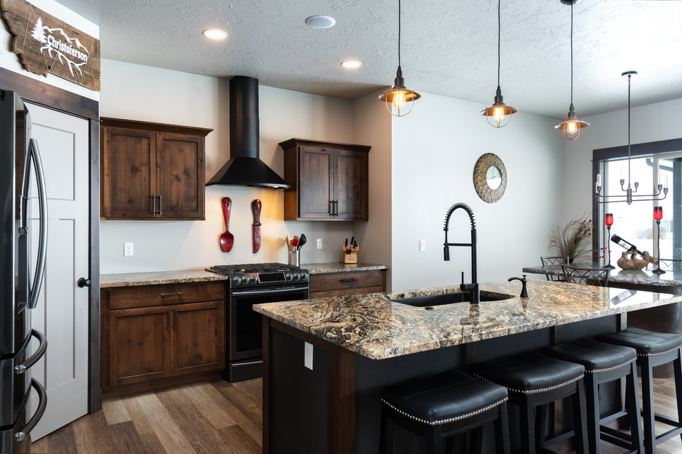 Mid-sized transitional l-shaped medium tone wood floor and brown floor eat-in kitchen photo with an undermount sink, shaker cabinets, medium tone wood cabinets, granite countertops, stainless steel appliances, an island and beige countertops